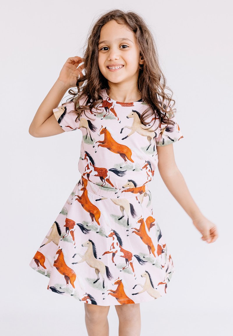 Pink dress featuring a repeated horse pattern in various colors. Short sleeves, round neckline, and a flared skirt design.