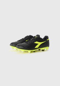 Black football boots made of synthetic material with textured design, featuring bright neon yellow accents and white studs for traction.