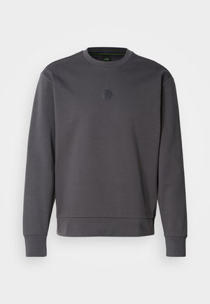 Sweatshirt gris charbon en tissu doux, avec un logo hexagonal sur la poitrine, des poignets côtelés et un col rond. Design simple et moderne.