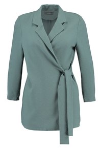 Zelený texturovaný blejzr s dlouhým rukávem, s designem do zavinování a zavíráním na pásek. Má klopový límec a rukávy délky po kotníky. Hladký povrch látky.