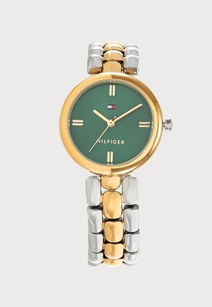 Reloj redondo con esfera verde, caja de oro y correa metálica enlazada en oro y plata que muestra la hora 10:09 con la aguja de segundos en 35 segundos.