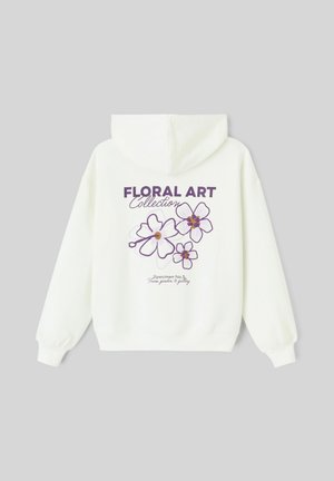Sweat à capuche blanc avec un motif floral violet dans le dos, texte indiquant "Collection ART FLORAL" avec du texte supplémentaire en plus petit en dessous.