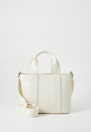 White, structured handbag with dual short handles and a detachable shoulder strap. Features embossed branding on the front and a smooth texture.
