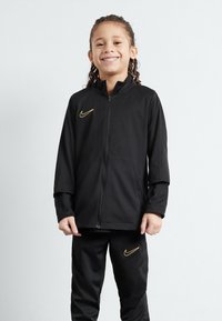 Nike Performance - ACADEMY 23 TRACK SUIT BRANDED UNISEX SET - Trainingsanzug - black/metallic gold Thumbnail-Bild 1