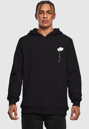 Black hoodie made of fabric, featuring a front pocket, drawstring hood, and white graphic of a figure holding two balloons on the chest.