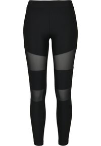 Leggings noirs avec une texture côtelée verticale, affichant des panneaux en mesh transparent sur les sections supérieure et inférieure des jambes. Taille élastique incluse.