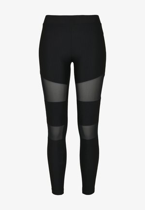 Leggings neri con texture a coste verticali, caratterizzati da pannelli in rete trasparente nelle sezioni superiore e inferiore delle gambe. Fascia in vita elastica inclusa.