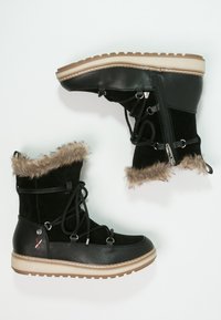 Botas de tobillo de ante y cuero negro con ribete de pelo sintético, diseño de cordones, cremallera lateral y suela de goma beige acolchada.