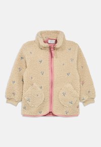 Veste en polaire crème avec une fermeture éclair rose, ornée de broderies florales, col montant, poches rondes avec une texture douce et poignets élastiques.