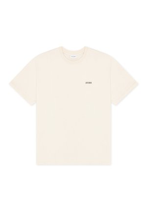 Κοντομάνικο T-shirt σε κρεμ χρώμα με στρογγυλή λαιμόκοψη, με μικρό μαύρο κείμενο "LES DEUX" στο αριστερό στήθος.