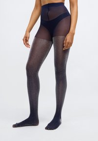 Marineblå højtaljede leggings med en gennemsigtig finish, der har en subtil glimmer-effekt, der går fra mørke til lysere nuancer ved fødderne.