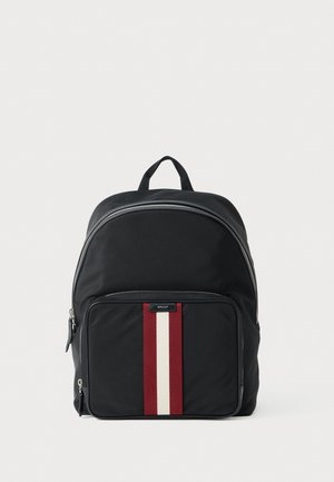 Black nylon backpack featuring a front pocket with a red and white vertical stripe, silver zippers, and a top handle.