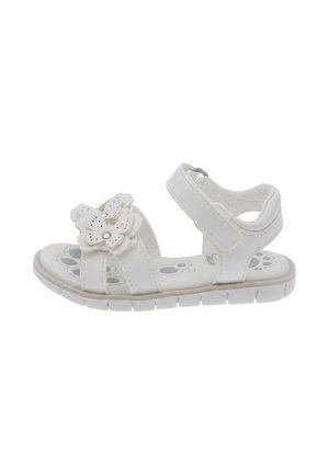 Sandalo bianco per bambino piccolo con cinturino alla caviglia in velcro e farfalla decorativa sulla fascia frontale, con motivo di impronte di zampe sulla soletta.