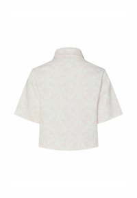 Camicia a maniche corte con colletto, con un motivo floreale rosa chiaro su sfondo bianco, caratterizzata da una vestibilità comoda e un tessuto liscio e testurizzato.
