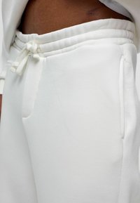 Witte sweatpants met een elastische tailleband en trekkoord, met zijzakken en een soepele, zachte textuur.