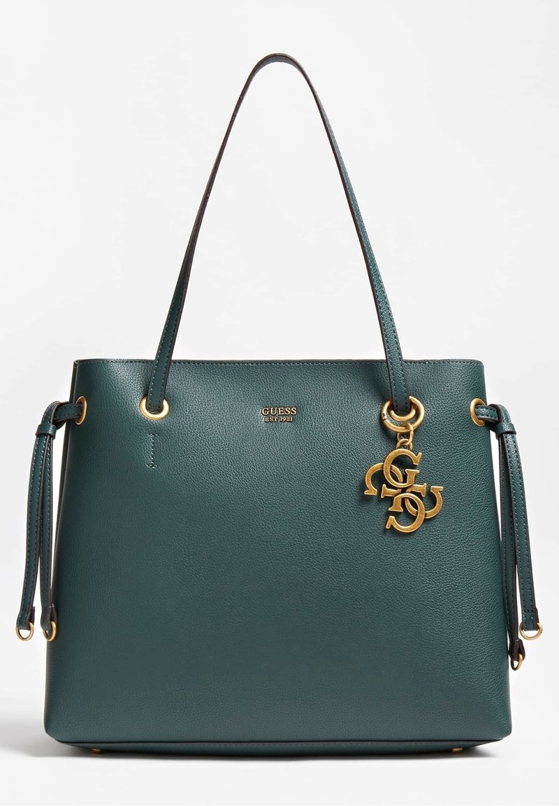 Teal læder tote bag med guld hardware, der har justerbare stropper og et aftageligt charms med logo-bogstaver. Glat tekstur, struktureret design.
