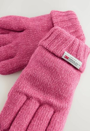 Gants en tricot rose avec des poignets côtelés, comportant une étiquette indiquant "3M Thinsulate". Tissu doux et texturé avec des sections de doigts distinctes.