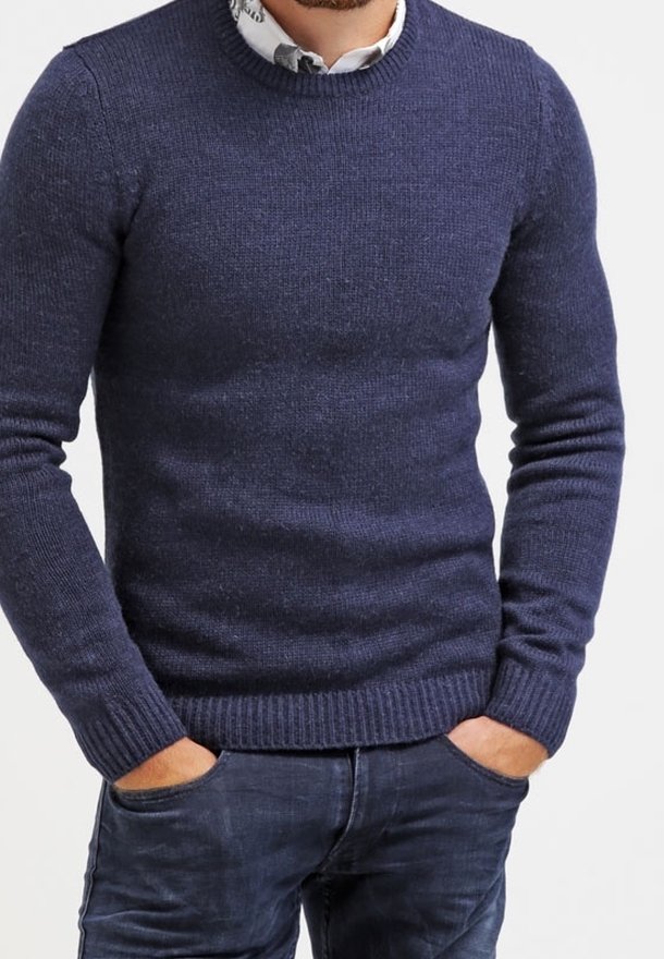 Marinblå stickad tröja med rund halsringning, ribbade ärmslut och nederkant. Bärs över en skjorta med krage, som har en texturerad tyg och åtsittande design.