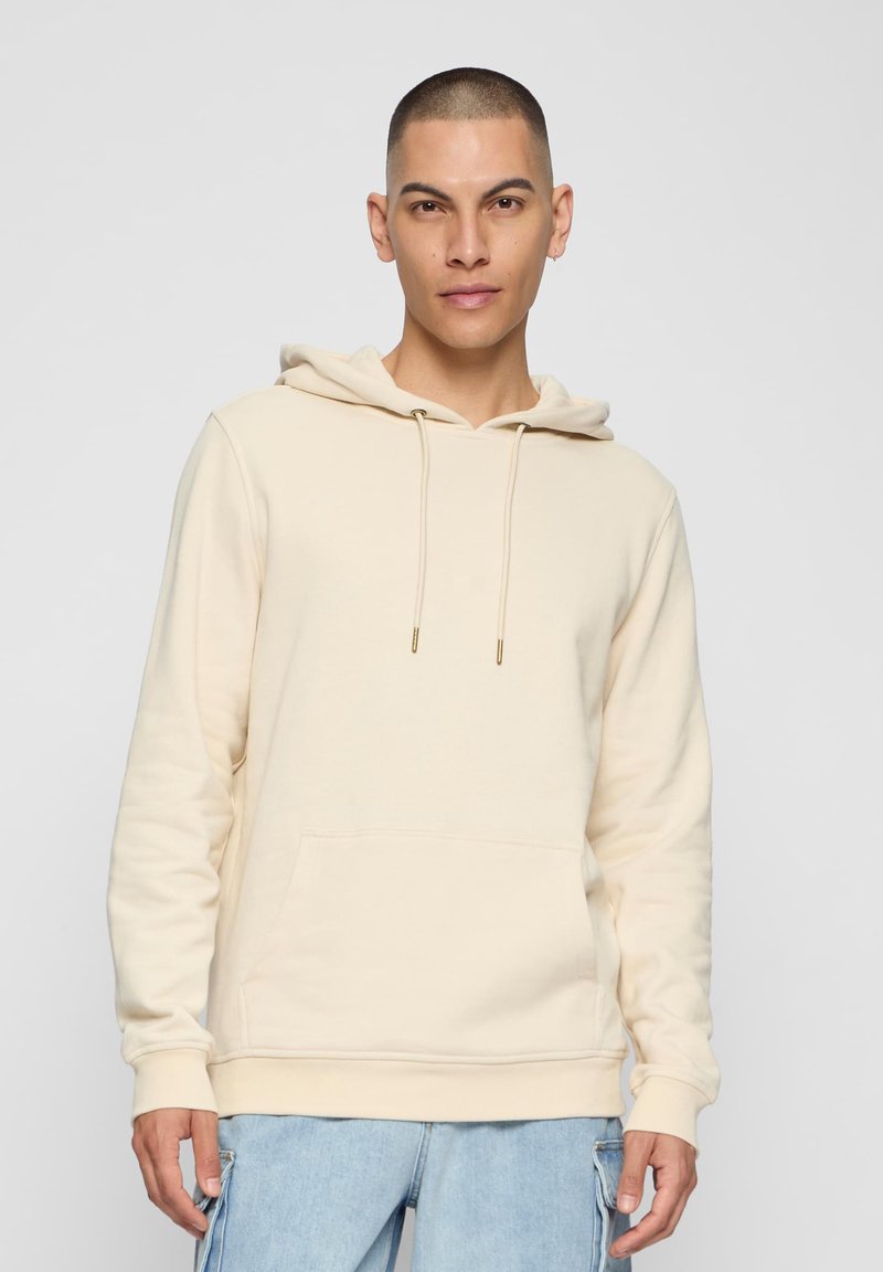 Felpa color crema con cappuccio e cordino, tasca frontale e polsini a costine. Realizzata in tessuto morbido, presenta un design semplice e casual.