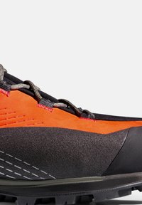 Laufschuh für Trailrunning mit einem orange-schwarzen Design, Wildleder- und strukturierten synthetischen Materialien, aufwendiger Schnürung und strapazierfähiger Gummisohle mit Profil.