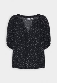 Sort bluse med hvidt mønster af små stjerner og prikker, korte pufærmer og en afslappet V-udskæring fra GAP.