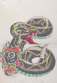 Serpente nera arrotolata con segni gialli e turchesi, bocca aperta che mostra i denti, vicino a una rosa nera stilizzata con fiamme rosse su sfondo bianco.