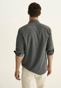 Grijs shirt met lange mouwen, een button-down kraag, opgerolde manchetten en een ontspannen pasvorm, met een gladde stofstructuur en een gebogen zoom.