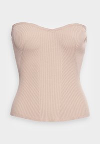 Beige strapless topp i ribbad textur med en åtsittande silhuett och en lätt hjärtformad halsringning. Sömmar längs framsidan.