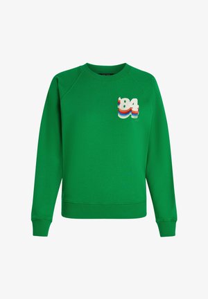 Grøn sweatshirt med ribbet rund hals og raglanærmer. Bemærkelsesværdigt detalje: broderet "84" i flerfarvede striber på brystet.