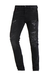 Jeans negros ajustados con detalles desgastados y parches descoloridos en los muslos y rodillas delanteras.