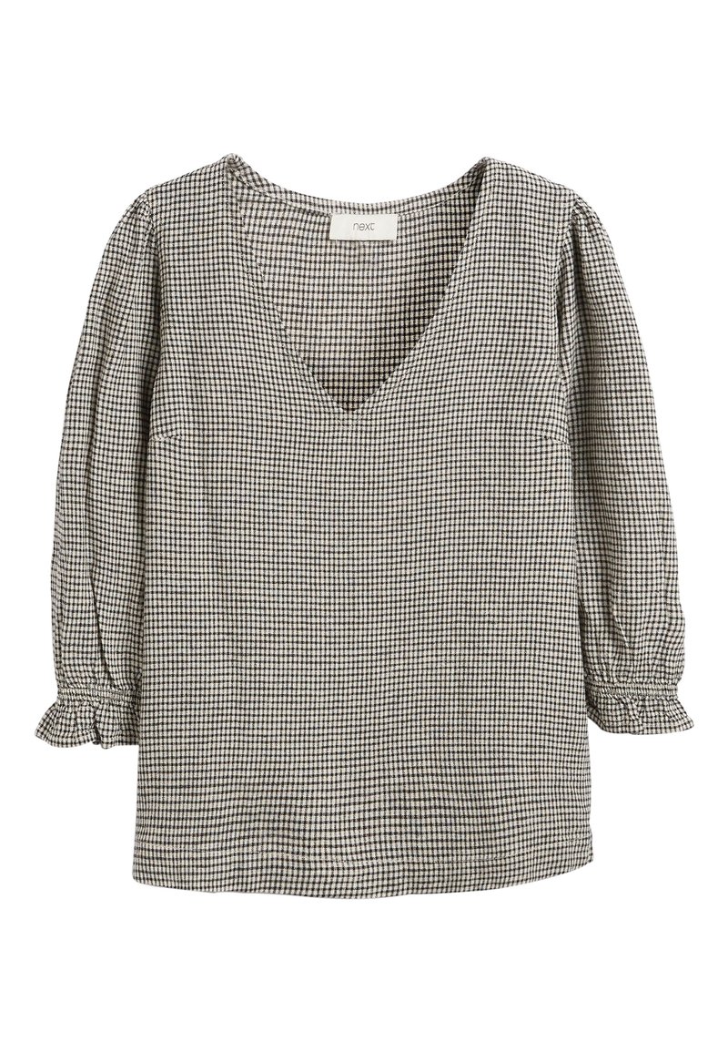 Black and white gingham blouse with a V-neck, three-quarter sleeves, and gathered cuffs. Textured fabric with a check pattern.