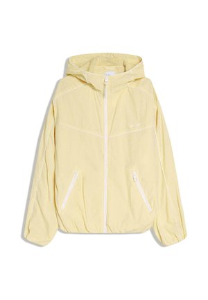 Lichtgele gewatteerde jas met capuchon, witte rits en twee schuin geplaatste zakken met rits, voorzien van witte biezen op mouwen en borst.