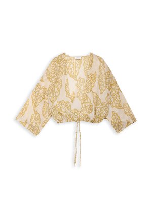 Blouse beige à manches longues, coupe ample, avec un motif de feuille abstraite dorée et un cordon à nouer à l'ourlet.