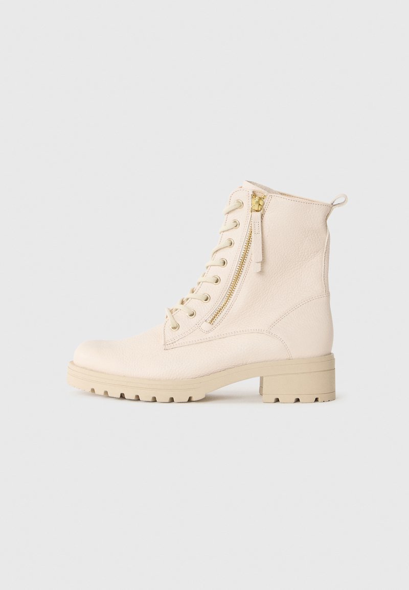 Stivaletto in pelle color crema con cerniera laterale, lacci frontali, tacco largo e linguetta di aiuto su uno sfondo bianco.