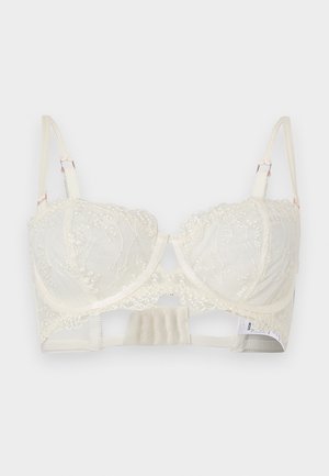Soutien-gorge à armatures en dentelle ivoire avec broderie florale, bretelles réglables et plusieurs agrafes au dos.