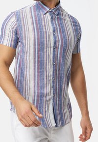 Short-sleeve button-up shirt with blue, beige, and red vertical stripes, featuring a textured fabric and a pointed collar.
