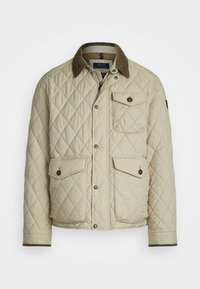 Beige quilted jacket with a corduroy collar, front pockets, and snap buttons. Textured fabric with diamond pattern and ribbed cuffs.