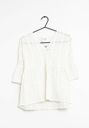 Top bianco a maniche corte in tessuto sangallo con scollo a V, caratterizzato da un orlo svasato e un motivo a spina di pesce su tutta la superficie.