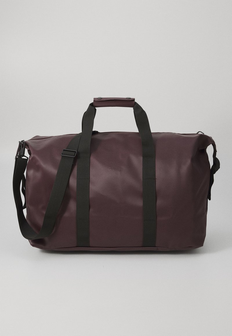 Maroon duffel bag made of smooth waterproof material, featuring black straps, zip closure, and a rectangular shape.