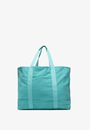 Bolsa de tela turquesa con dos asas para el hombro, forma rectangular y detalles simples cosidos sobre un fondo blanco.