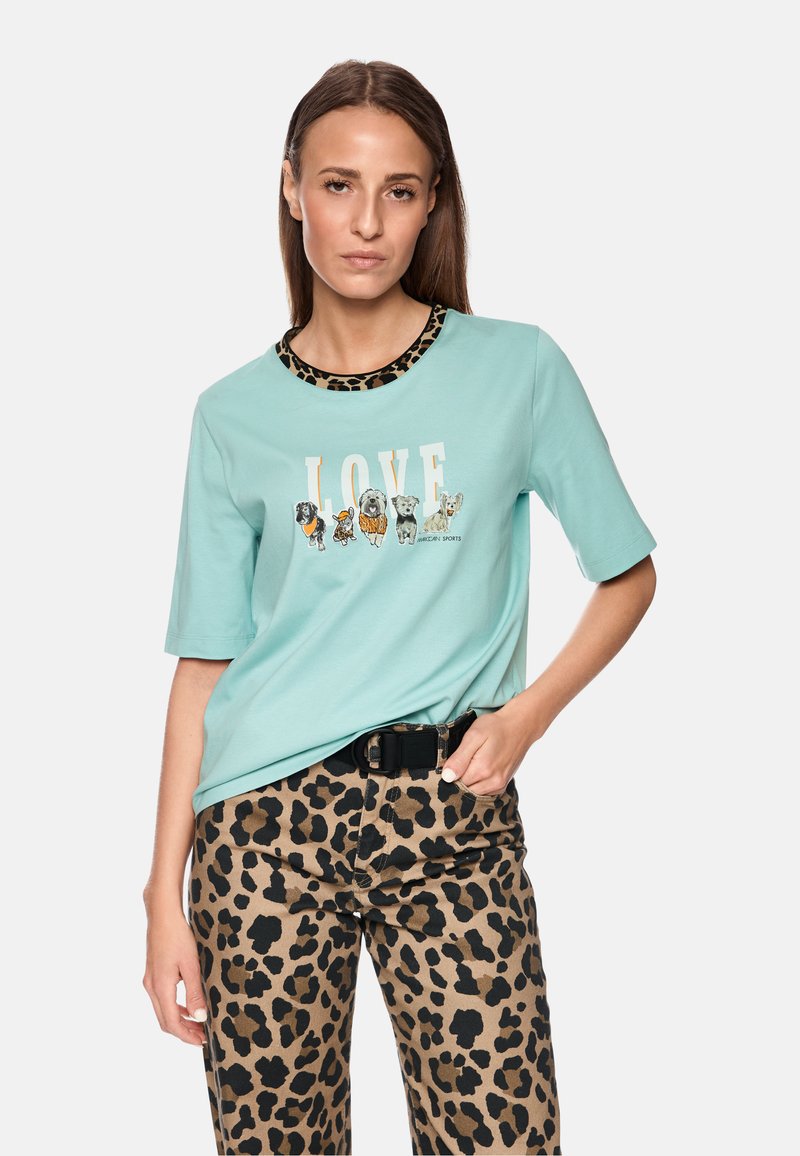 Mint green short-sleeve T-shirt featuring animal illustrations and "LOVE" text; paired with brown leopard print high-waisted pants.