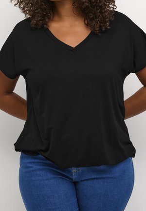 Black V-neck t-shirt made of soft fabric, featuring short sleeves and a relaxed fit, paired with blue denim jeans.