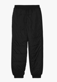 Czarne puchowe spodnie z teksturowanym wykończeniem, elastycznym pasem i zwężanymi nogawkami. Posiadają poziome przeszycia oraz boczne panele dla dodatkowego efektu.