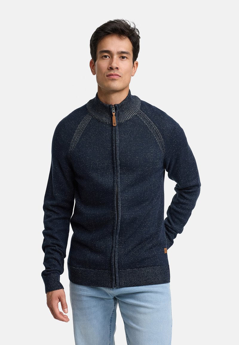Cardigan in maglia blu navy con zip, colletto alto, motivo testurizzato e polsini a coste; presenta una toppa con logo sul lato inferiore.