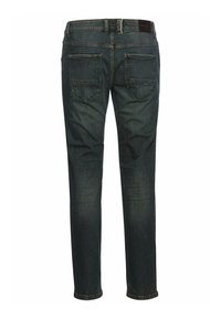 Donker denim jeans met een slim fit, voorzien van twee achterzakken en een leren label op de tailleband. Zachte textuur met een lichte stretch.
