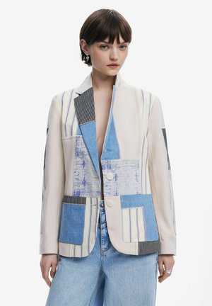 Patchwork blazer with varied denim and fabric panels in blue, white, and black stripes; two button closure and notched lapel design.