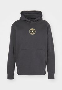 Sweat à capuche noir avec poche avant et petit logo circulaire jaune du Paris Saint-Germain sur la poitrine.