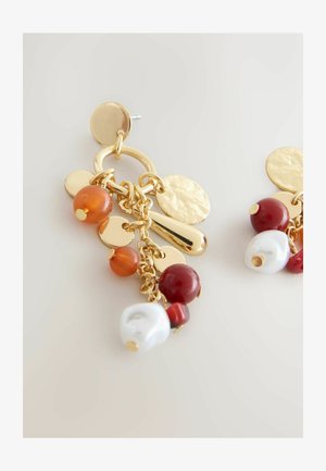 Gold-tone earrings featuring hanging beads in orange, red, and white, with textured circular accents and a mixed metal design.