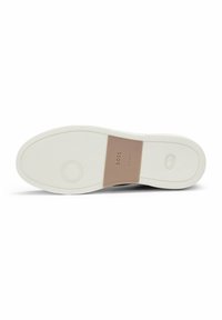 Shoe sole featuring a white rubber base, textured for grip, with a brown accent label marked “BOSS” at the center.