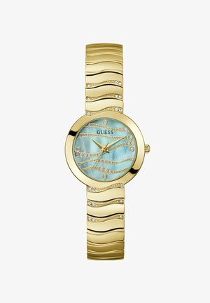 Montre dorée avec un bracelet en design ondulé, dotée d'un cadran bleu clair iridescent orné de cristaux étincelants et d'un logo minimaliste.
